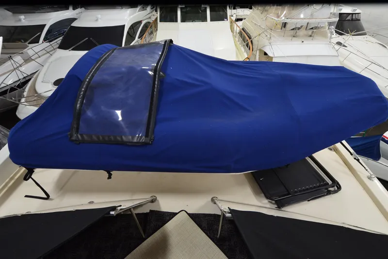 Slide: The Image of 1990 Jefferson 52 Marquessa ED yacht with blue cover in marina setting. - 51