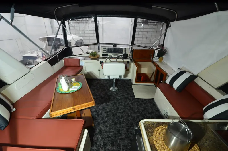 Slide: The Image of Interior of a 1990 Jefferson 52 Marquessa ED yacht with seating and helm. - 53