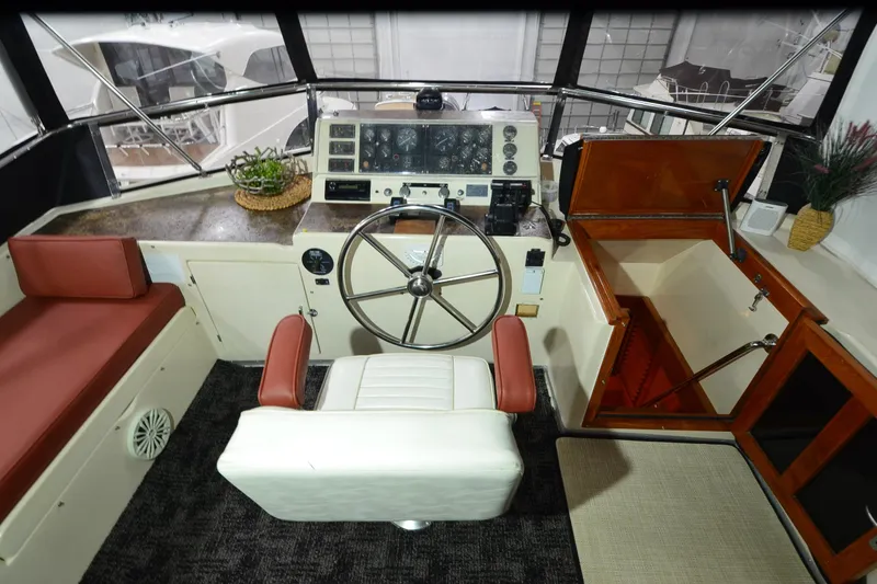 Slide: The Image of Cockpit of 1990 Jefferson 52 Marquessa ED yacht with steering wheel and seating. - 54