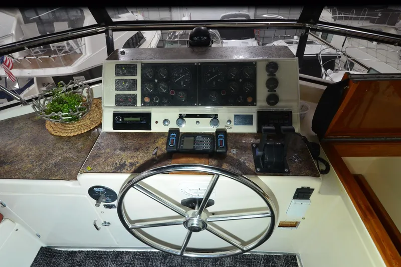 Slide: The Image of 1990 Jefferson 52 Marquessa ED yacht helm with steering wheel and control panel. - 55