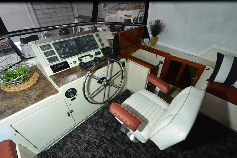 Slide: The Image of Captain's helm of 1990 Jefferson 52 Marquessa ED yacht with steering wheel and control panel. - 56