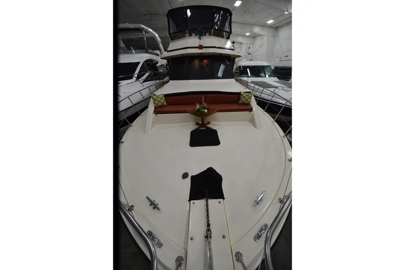 Slide: The Image of 1990 Jefferson 52 Marquessa ED yacht with spacious deck and seating area in a showroom. - 57