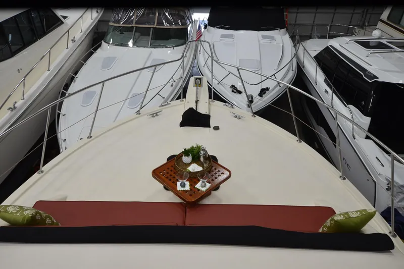 Slide: The Image of 1990 Jefferson 52 Marquessa ED yacht with elegant deck setup, docked among other boats. - 62