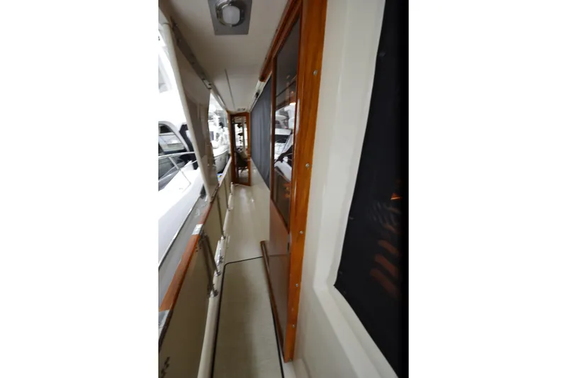 Slide: The Image of Narrow walkway on 1990 Jefferson 52 Marquessa ED yacht with wooden trim and windows. - 67