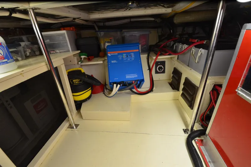Slide: The Image of Engine room of a 1990 Jefferson 52 Marquessa ED yacht with equipment and storage. - 68