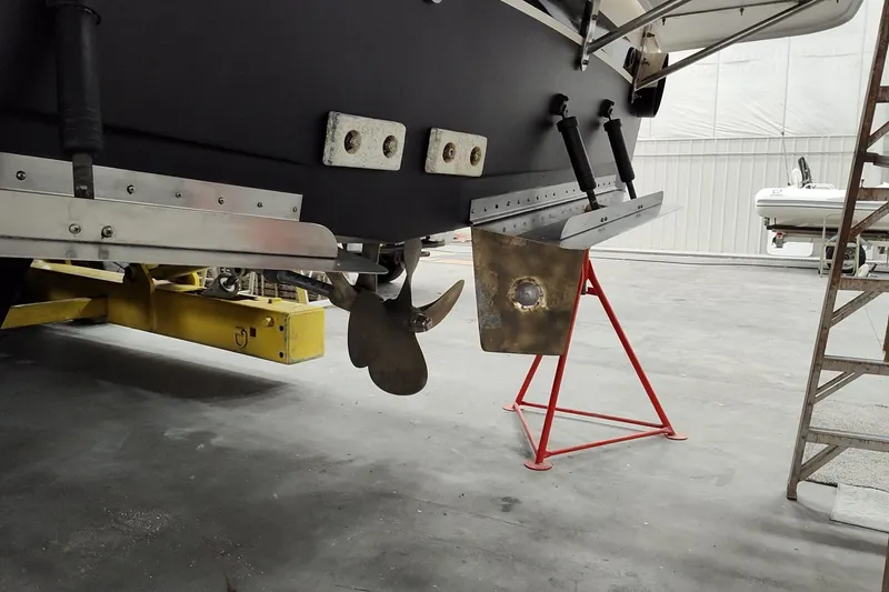 Slide: The Image of 1990 Jefferson 52 Marquessa ED boat propeller and rudder in a maintenance facility. - 8