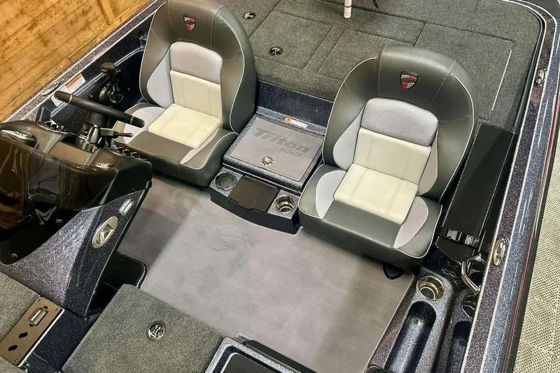 Slide: The Image of 2026 Triton 18 TrX boat interior with dual seats and steering console. - 13