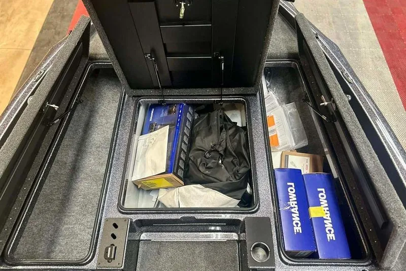 Slide: The Image of Interior storage compartments of a 2026 Triton 18 TrX boat, featuring organized equipment. - 14