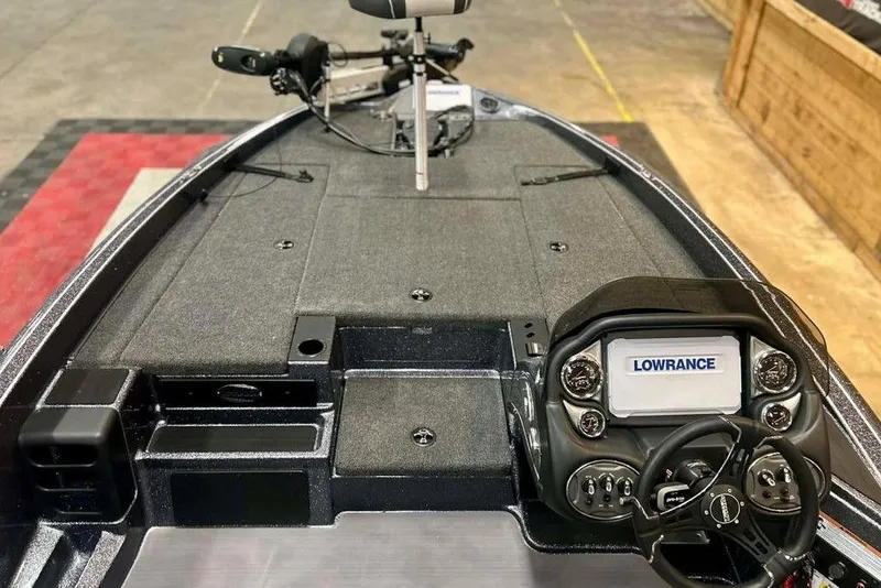 Slide: The Image of 2026 Triton 18 TrX boat dashboard with Lowrance electronics and steering wheel. - 7