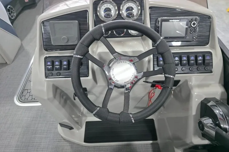 Slide: The Image of 2026 Sylvan Mirage X5 boat cockpit with modern steering and controls. - 11