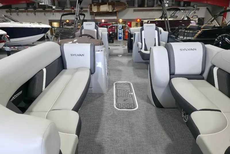 Slide: The Image of 2026 Sylvan Mirage X5 pontoon boat on trailer in indoor storage facility. - 6