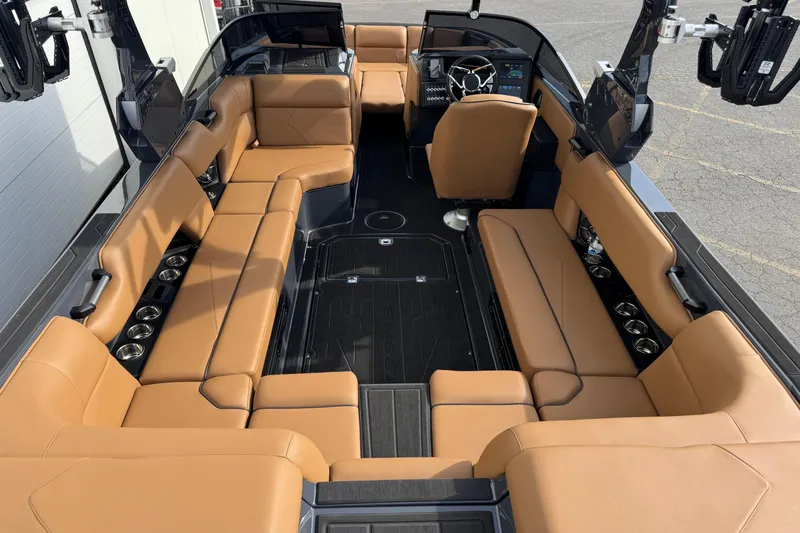 Slide: The Image of Luxurious interior of 2026 Moomba Tykon boat with tan leather seating and modern dashboard. - 11