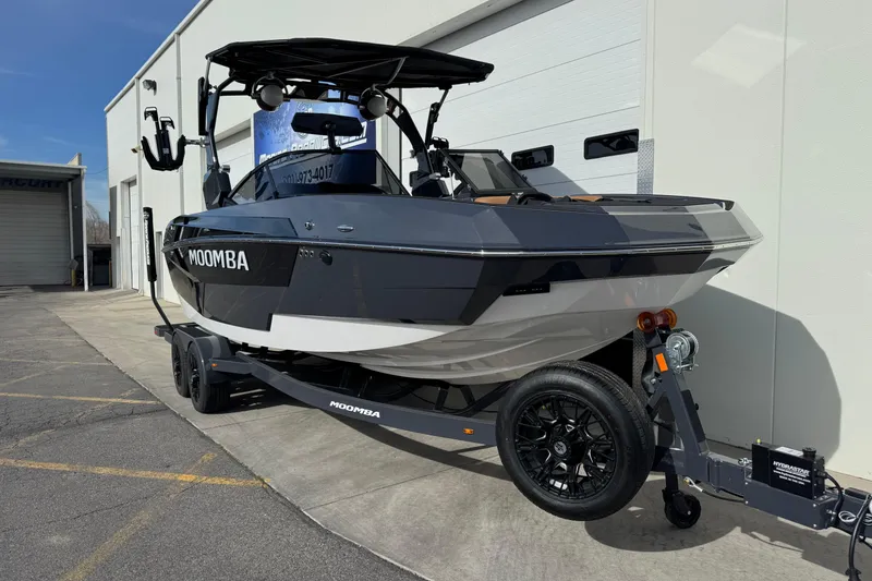 Slide: The Image of 2026 Moomba Tykon boat on trailer, parked outside a building. - 3