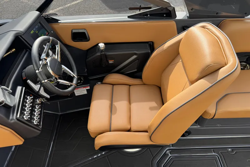 Slide: The Image of 2026 Moomba Tykon interior with tan leather seat and modern steering wheel. - 9