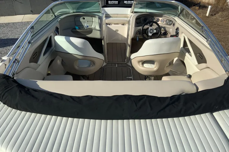 Slide: The Image of 2007 Bryant 206 boat interior with white seating and modern dashboard design. - 4