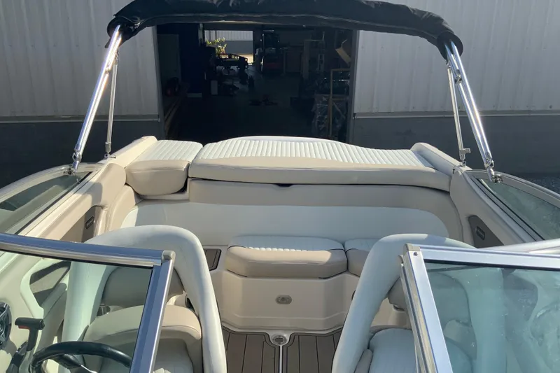 Slide: The Image of Interior of a 2007 Bryant 206 boat with beige seating and canopy. - 5