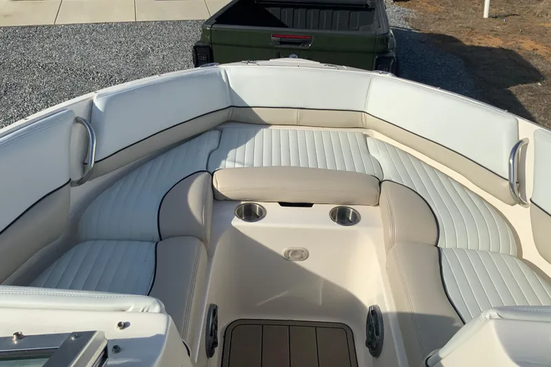 Slide: The Image of 2007 Bryant 206 boat interior with white cushioned seating and cup holders. - 6