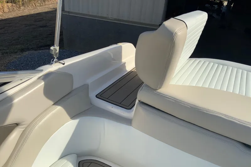 Slide: The Image of 2007 Bryant 206 boat interior with beige and white seating, outdoor setting. - 8