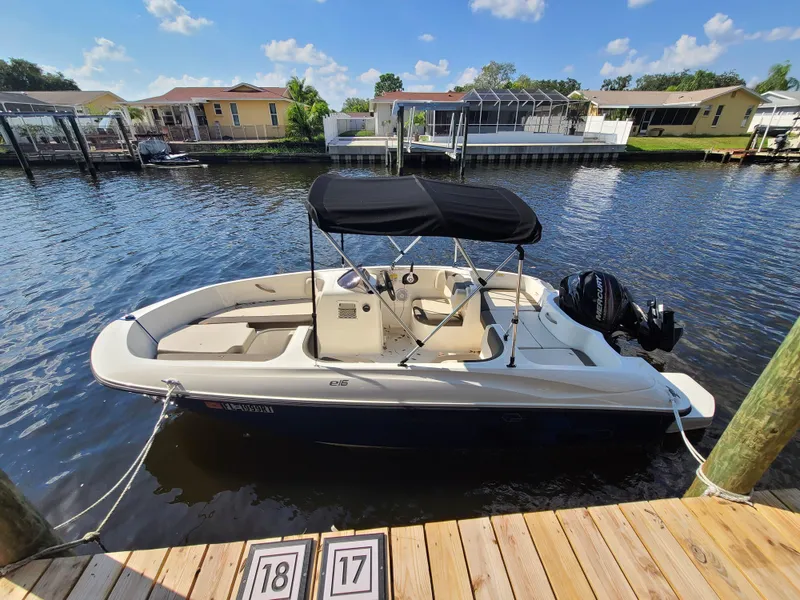 The Image of 2019 Bayliner Element E16 boat on trailer, displayed outdoors under clear sky. - 0