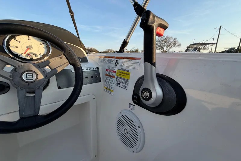 Slide: The Image of 2019 Bayliner Element E16 dashboard with steering wheel and throttle control. - 23