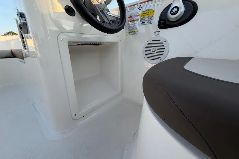 Slide: The Image of 2019 Bayliner Element E16 boat interior with steering wheel and seating area. - 24