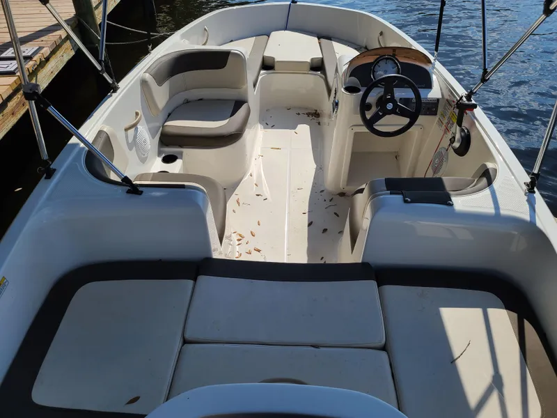 Slide: The Image of 2019 Bayliner Element E16 boat with Mercury 60 engine, parked outdoors under clear sky. - 3