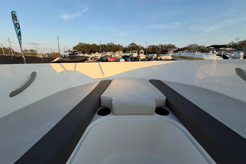 Slide: The Image of 2019 Bayliner Element E16 boat interior with seating, docked at marina under clear sky. - 30
