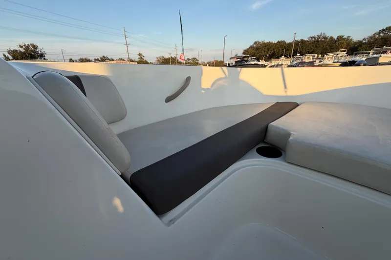 Slide: The Image of 2019 Bayliner Element E16 boat interior with cushioned seating and cup holder. - 32