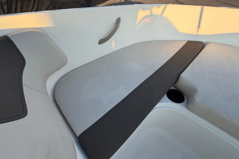 Slide: The Image of 2019 Bayliner Element E16 boat interior seating with gray and black cushions. - 33