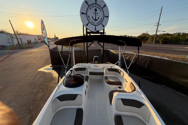 Slide: The Image of 2019 Bayliner Element E16 boat with seating, docked at sunset. - 40