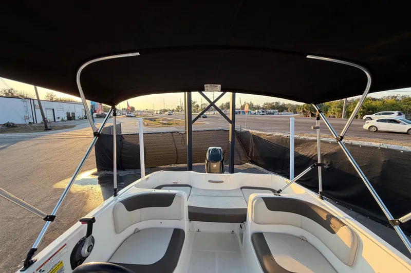 Slide: The Image of 2019 Bayliner Element E16 boat interior with canopy, parked on a sunny day. - 42