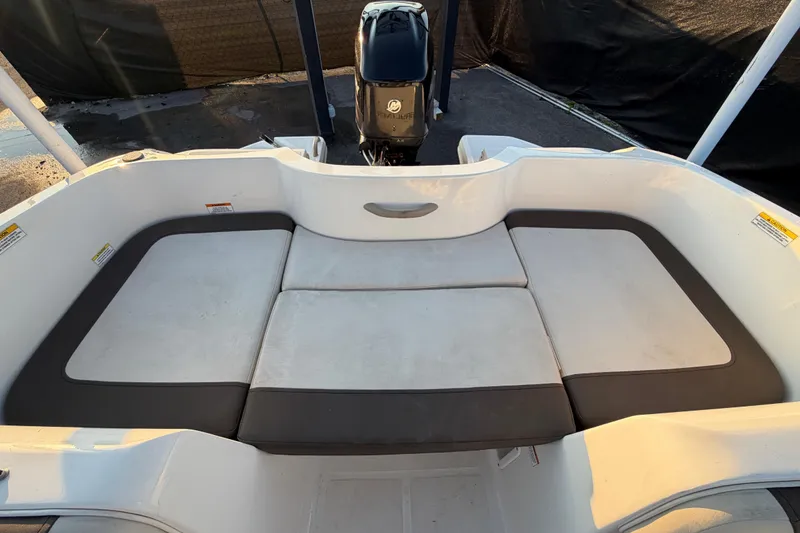 Slide: The Image of 2019 Bayliner Element E16 boat interior with cushioned seating and outboard motor. - 50