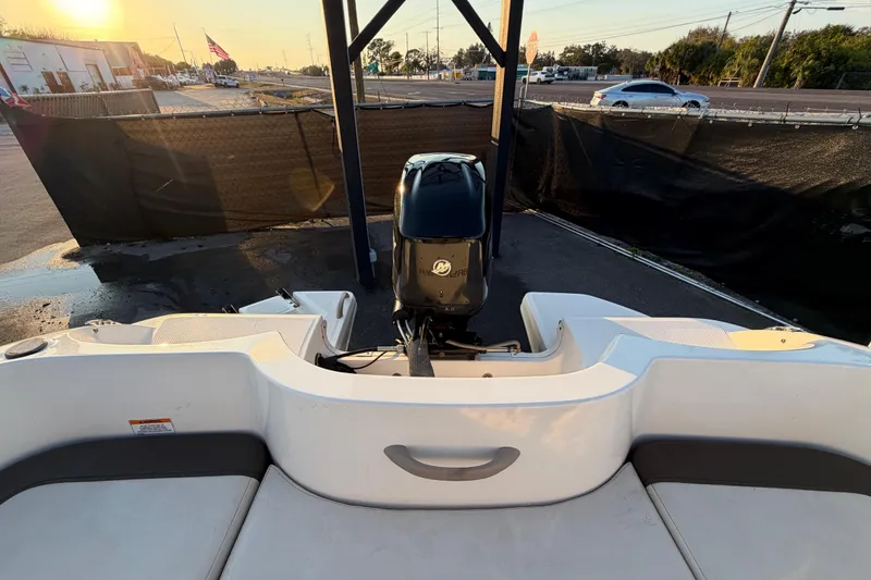 Slide: The Image of 2019 Bayliner Element E16 boat with outboard motor at sunset in a parking area. - 51