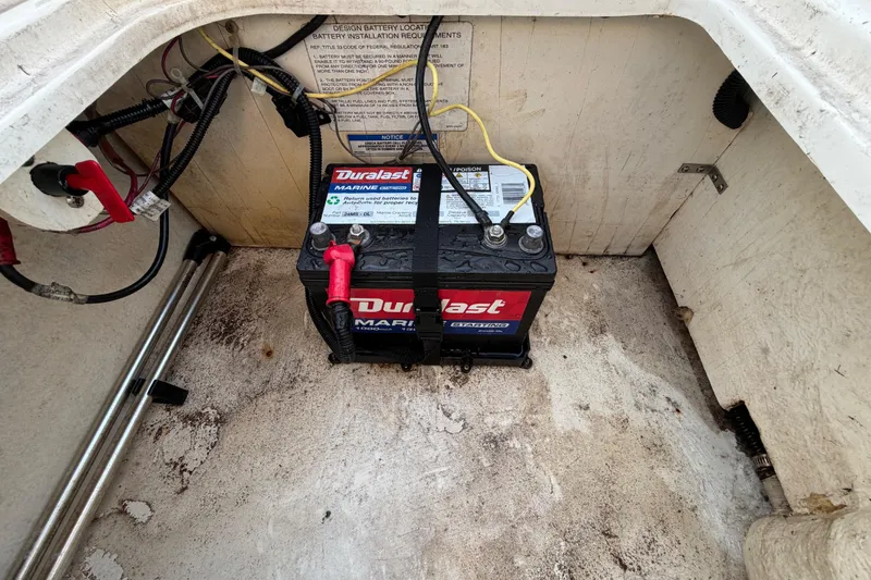 Slide: The Image of 2019 Bayliner Element E16 boat battery compartment with Duralast marine battery. - 58