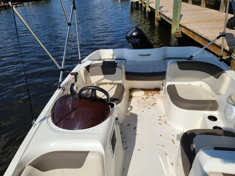 Slide: The Image of 2019 Bayliner Element E16 boat with Mercury engine on trailer, under sunny sky. - 6