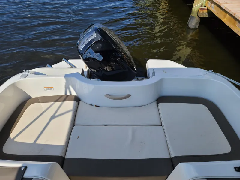 Slide: The Image of 2019 Bayliner Element E16 boat on trailer at sunset, displayed at a dealership. - 8