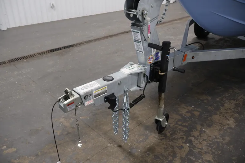 Slide: The Image of Trailer hitch of a 2026 Yamaha Boats SX195 in a garage setting. - 46