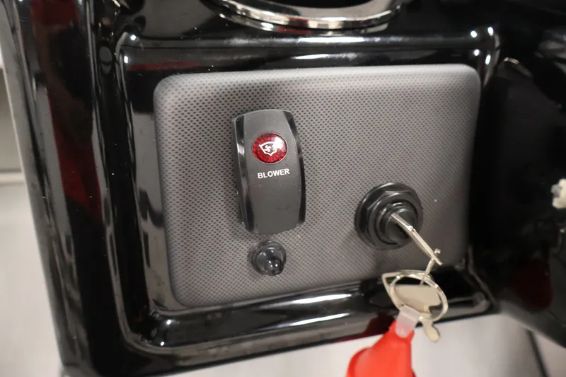 Slide: The Image of Control panel of 2026 Yamaha Boats SX195 with blower switch and ignition key. - 27