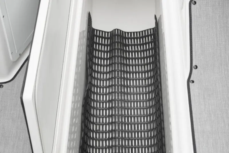 Slide: The Image of 2026 Yamaha Boats SX195 storage compartment with black mesh lining. - 5
