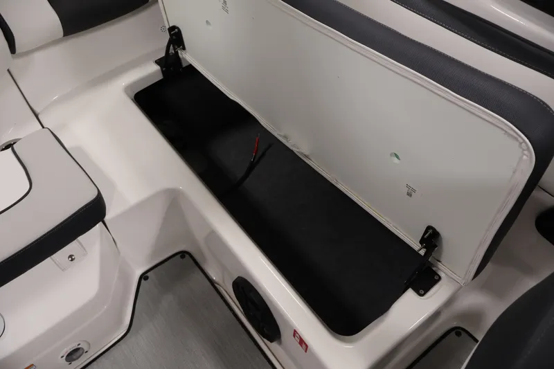 Slide: The Image of 2026 Yamaha Boats SX195 storage compartment with open lid, showcasing spacious interior. - 42