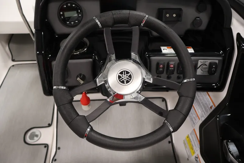 Slide: The Image of Steering wheel of 2026 Yamaha Boats SX195, featuring modern dashboard controls. - 23