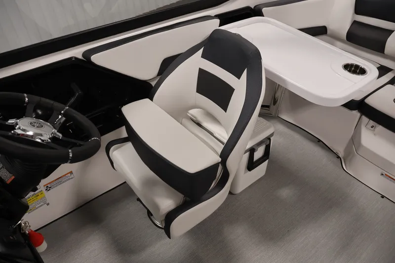 Slide: The Image of 2026 Yamaha Boats SX195 interior with steering wheel, captain's chair, and table. - 32