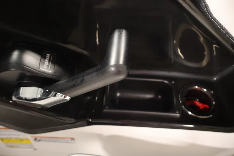 Slide: The Image of Close-up of 2026 Yamaha SX195 boat throttle control and cup holder. - 29