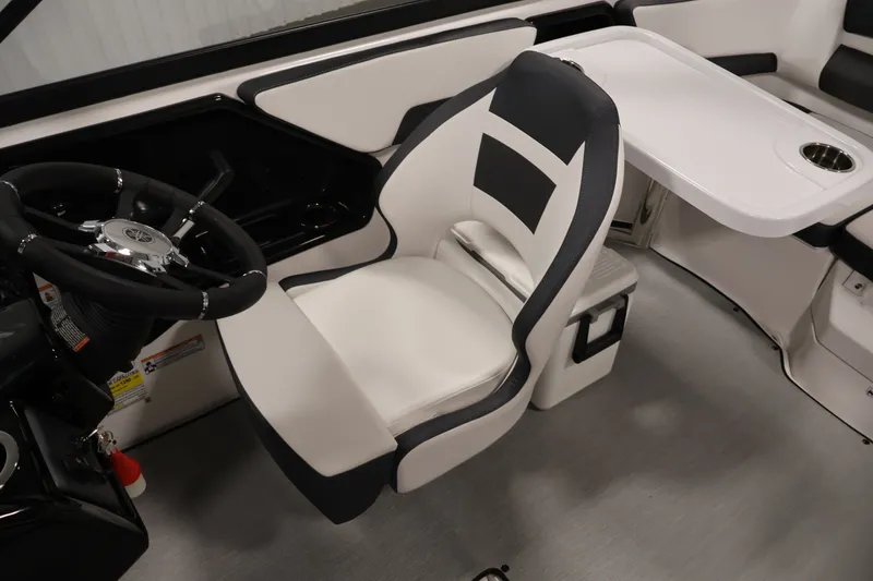 Slide: The Image of Interior of 2026 Yamaha Boats SX195, featuring steering wheel and seating area. - 31