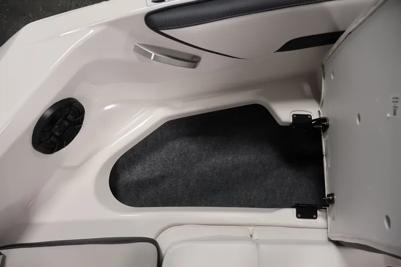 Slide: The Image of 2026 Yamaha Boats SX195 interior storage compartment with open hatch and speaker. - 20
