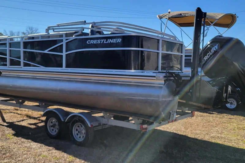 Slide: The Image of 2020 Crestliner 200 Rally DX CS pontoon boat on trailer, featuring Mercury outboard motor. - 3