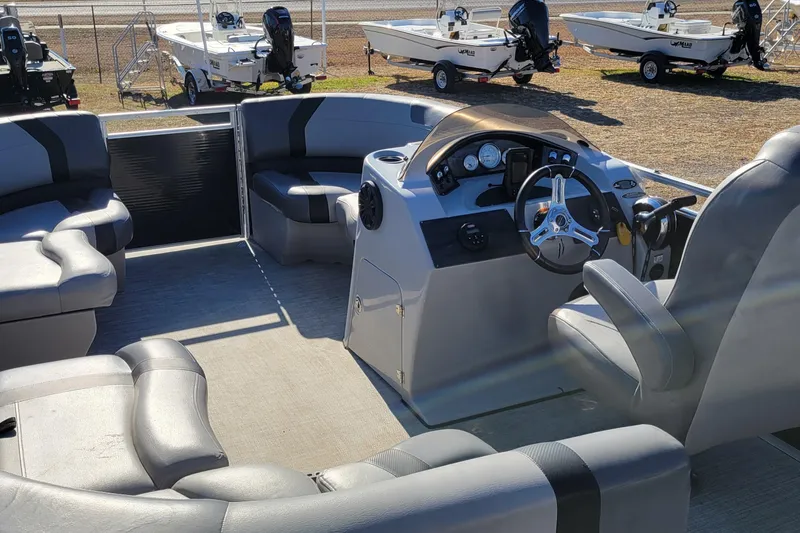 Slide: The Image of 2020 Crestliner 200 Rally DX CS pontoon boat interior with steering console and seating. - 5