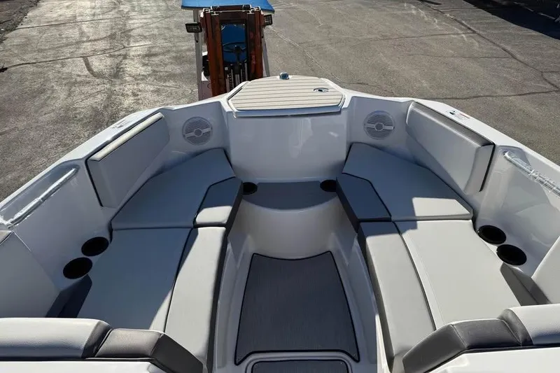 Slide: The Image of 2026 Yamaha Boats AR220 interior with spacious seating and cup holders. - 11