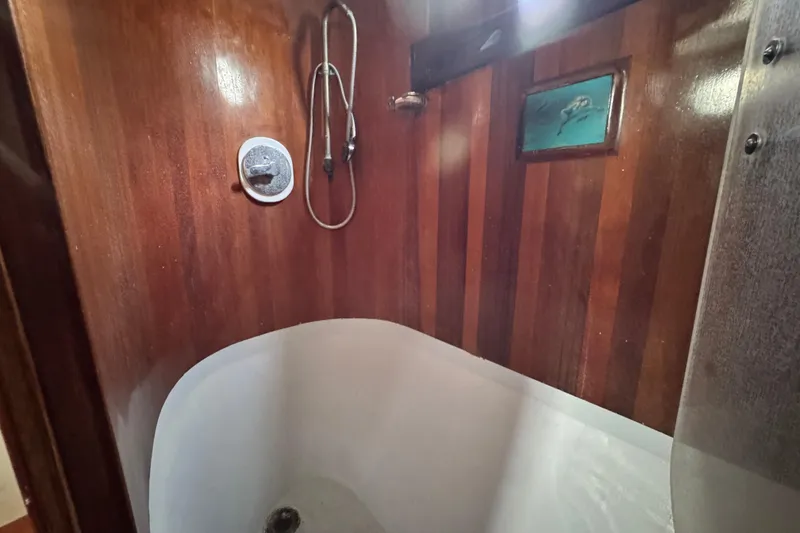 Slide: The Image of Wood-paneled bathroom with vintage tub and shower in 1918 Peterson Tug. - 10