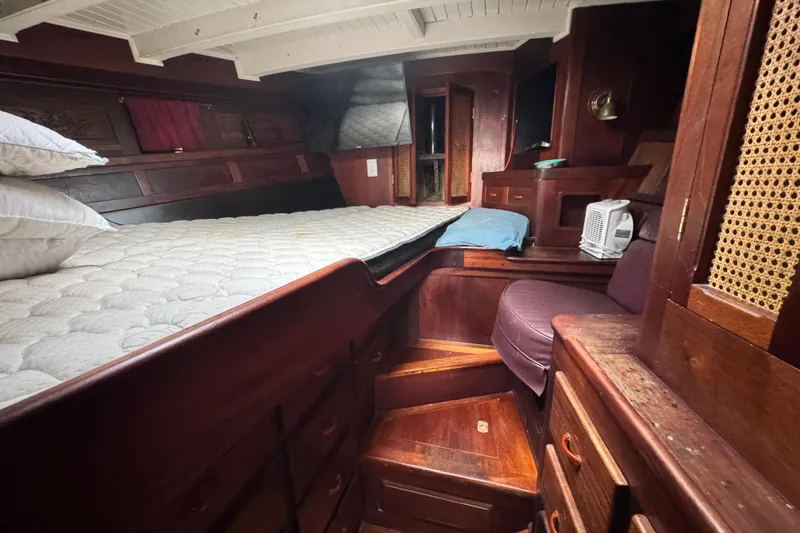 Slide: The Image of Cozy wooden cabin interior of 1918 Peterson Tug with bed and storage. - 11